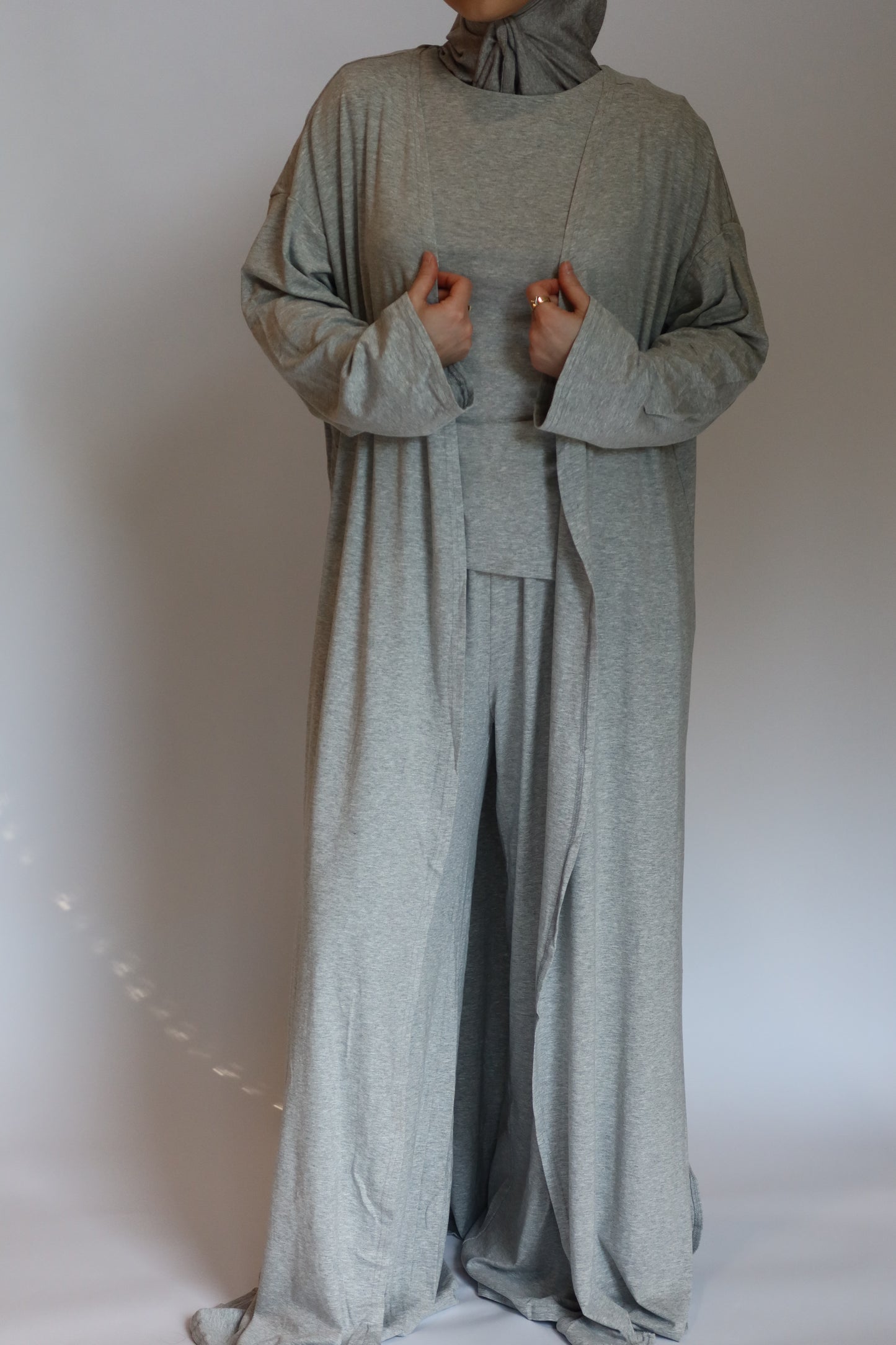 Person wearing a gray outfit against a plain background